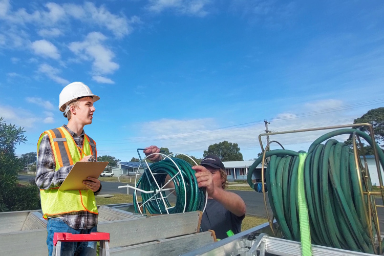 
Post-rinsing, batemansbay gutter cleaner prepares his hose equipment for transport.